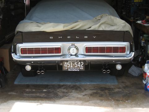 1968 Shelby GT500 - The rear of a 1968 Shelby GT500 is visible, the distinctive Shelby badging and dual exhaust pipes.