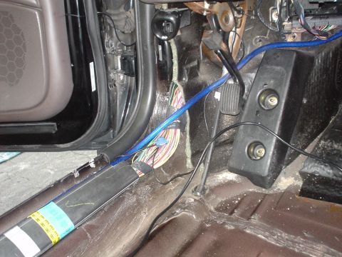 1999 Ford Taurus - Picture of h driver side kick pannel and my massive 4g cable for the amps, along with my crappy temp. connections of the signal mirrors.
