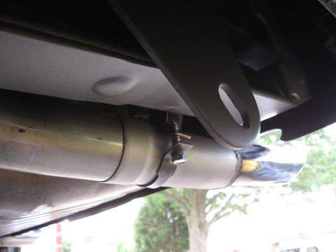 1968 Shelby GT500 - Close-up view of a vehicle's exhaust system, showing a chrome tip and mounting hardware.