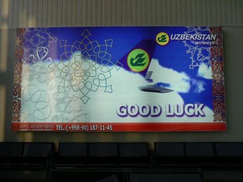 1989 Ford Bronco - An advertisement for Uzbekistan Airways features a plane tail and the words 'GOOD LUCK'.