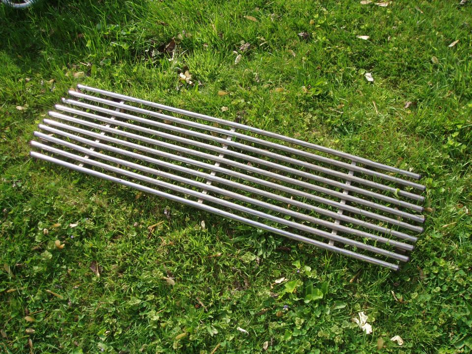 Chrome grille with horizontal bars on grass