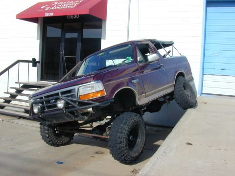 1996 Ford Bronco - This modified Ford Bronco is parked on an incline, its off-road capabilities.