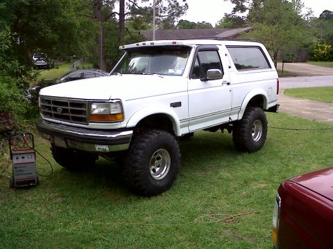 1996 Ford Bronco - This lifted 1996 Ford Bronco is parked on a grassy area next to a battery charger.