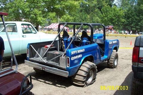 1996 Ford Bronco - Modified off-road vehicle with custom roll cage and "Jeff's Bronco Graveyard" text. Multiple vehicles are present at the event.