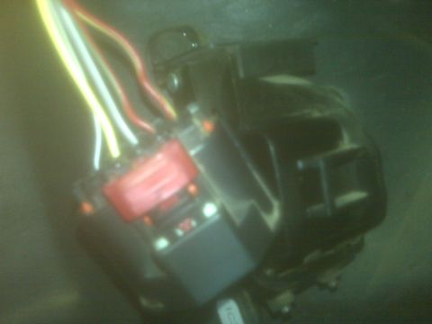 2001 Ford F-250 - A close-up view of a vehicle's electrical wiring harness and a red relay component.