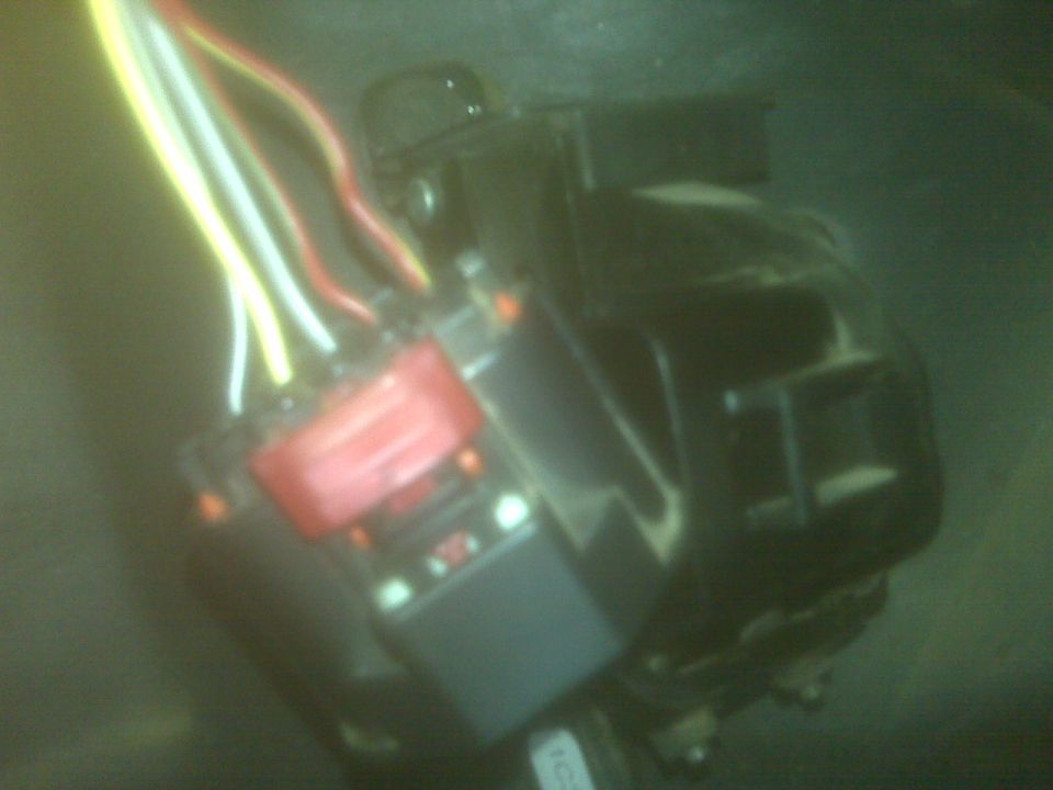 Close-up of a red relay and wiring harness with yellow, white, and red wires