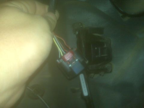 2001 Ford F-250 - A close-up view of a vehicle's wiring harness and connector, possibly for a repair.