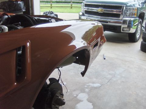 1980 Chevrolet Camaro - A car fender is shown in a garage, with a modern pickup truck parked behind it.