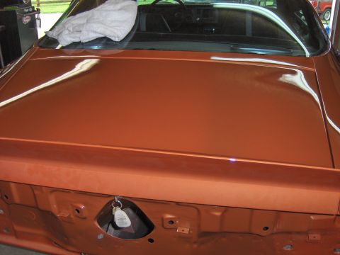 1980 Chevrolet Camaro - The rear of an orange 1980 Chevrolet Camaro shows its trunk lid and interior details, with a key fob attached.