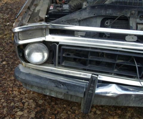 1976 Ford F-150 - Front view of a 1973 Ford F-150 with its hood open, revealing the engine bay and radiator.