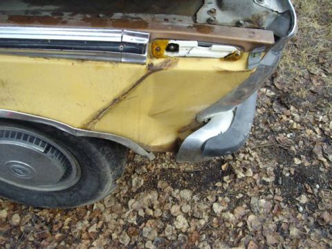 1976 Ford F-150 - Rear quarter panel and bumper damage on a yellow truck.