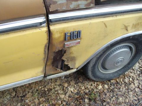 1976 Ford F-150 - The rear fender of a yellow Ford F-150 shows significant rust damage and a "Trailer Special" badge.