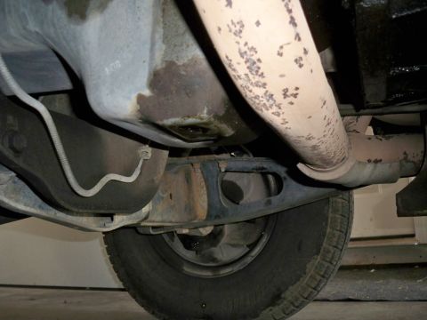 1994 Ford Bronco - Underside view of a vehicle's exhaust system and oil pan.