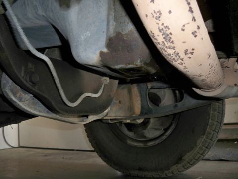 1994 Ford Bronco - Underside view of vehicle components including suspension, exhaust, and a tire.
