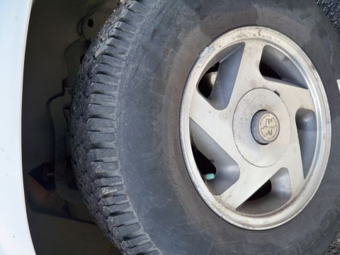 1994 Ford Explorer - A close-up view of a vehicle's wheel and tire, highlighting the rim and tire tread.