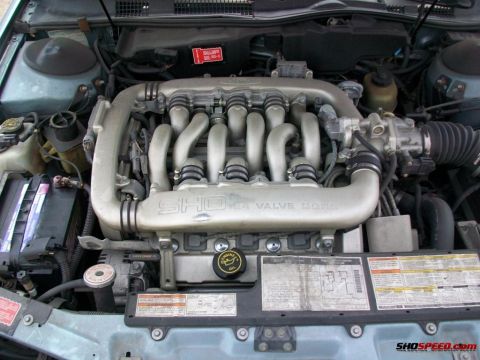 1993 Ford Taurus - The engine bay of a 1993 Ford Taurus SHO, its distinctive V6 24-valve DOHC engine.