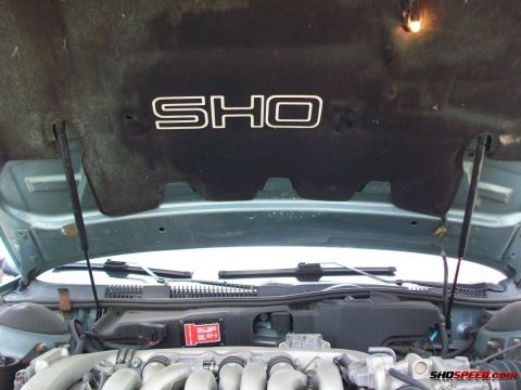 1993 Ford Taurus - The SHO emblem is visible on the underside of the hood in this 1993 Ford Taurus engine bay.