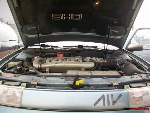 1993 Ford Taurus - Engine bay of a 1993 Ford Taurus SHO, the V6 engine and distinctive SHO badging.