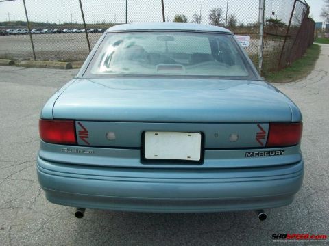 1993 Ford Taurus - Rear view of a light blue Mercury Sable sedan, identified by its 'Mercury' and 'Aluminum' badging.