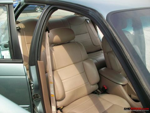 1993 Ford Taurus - Interior view of a 1993 Ford Taurus, tan leather seats and a center console.