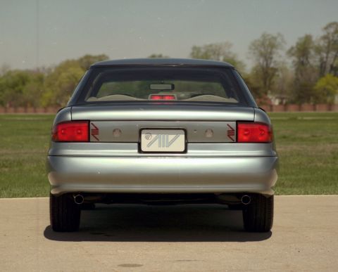1993 Ford Taurus - Silver sedan with 'AIV' badging on the rear, seen from behind.