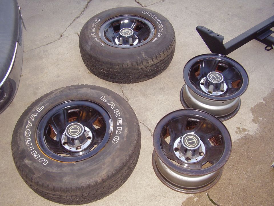 Four wheels and tires with Uniroyal Laredo branding