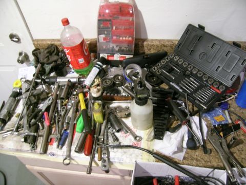 1995 Ford Probe - A collection of tools and a beverage sit on a counter, suggesting a work-in-progress or completed project.