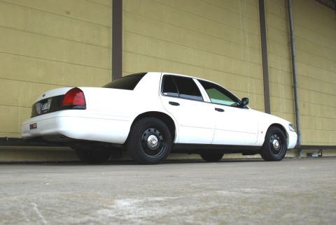 1998 Ford Crown Victoria - Rear 3/4 view of a white 1998 Ford Crown Victoria parked outdoors.