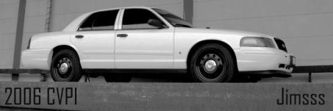 1998 Ford Crown Victoria - White 2006 Ford Crown Victoria Police Interceptor parked on a raised platform.