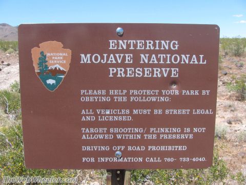 1996 Ford C-350 (Centurion Conversions) - Entering Mojave National Preserve sign lists park rules and a contact phone number.