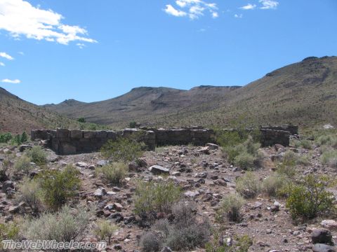 1996 Ford C-350 (Centurion Conversions) - Ruins of a stone structure in a dry, mountainous desert environment.