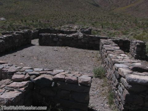 1996 Ford C-350 (Centurion Conversions) - Stone ruins are visible in a dry, hilly landscape, with vegetation growing around the structures.