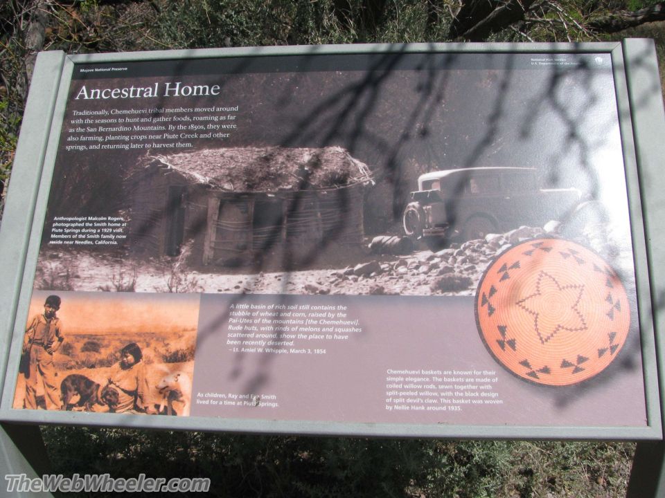 Exhibit sign about the Ancestral Home of the Chemehuevi people, showing a dwelling, a vintage truck, and a basket