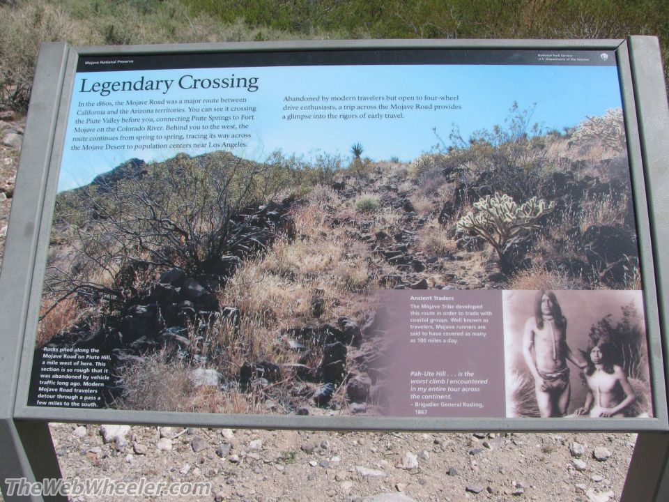 Informational sign detailing the history and terrain of the Mojave Road, with images of the landscape and Native Americans