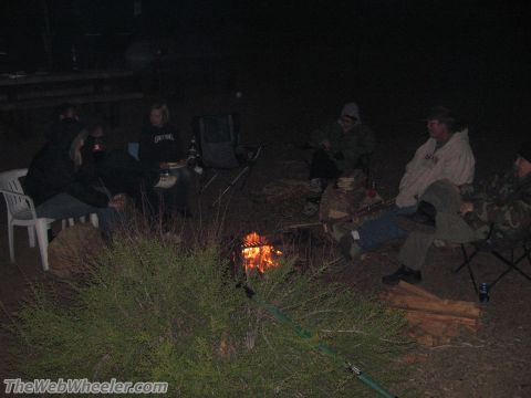1996 Ford C-350 (Centurion Conversions) - People gathered around a campfire at night, enjoying the outdoors.