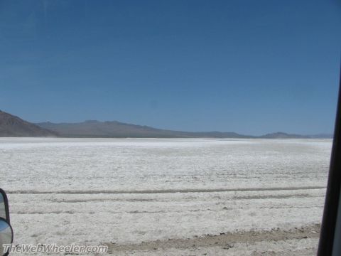 1996 Ford C-350 (Centurion Conversions) - View from a vehicle's side mirror shows the expansive white salt flats stretching towards distant mountains.