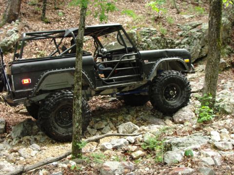 1967 Ford Mustang - Modified 1970s Ford Bronco navigates a challenging rocky off-road course.