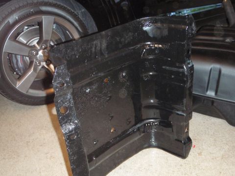 1995 Ford Bronco - Close-up of a black painted vehicle frame part, possibly from the undercarriage.
