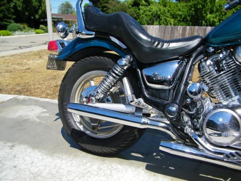 1992 Yamaha Virago - Close-up view of a motorcycle's rear wheel, exhaust pipe, and seat.