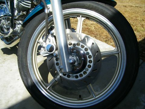 1992 Yamaha Virago - This image focuses on the front wheel assembly of a motorcycle, highlighting the brake system and wheel design.