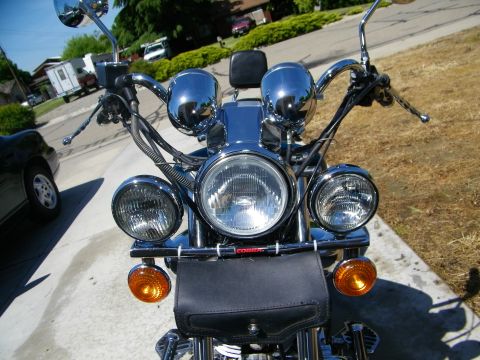 1992 Yamaha Virago - Front view of a motorcycle dual headlights, chrome details, and a leather pouch attached to the handlebars.