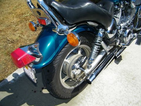 1992 Yamaha Virago - Rear view of a teal motorcycle, showing the fender, wheel, and exhaust system.