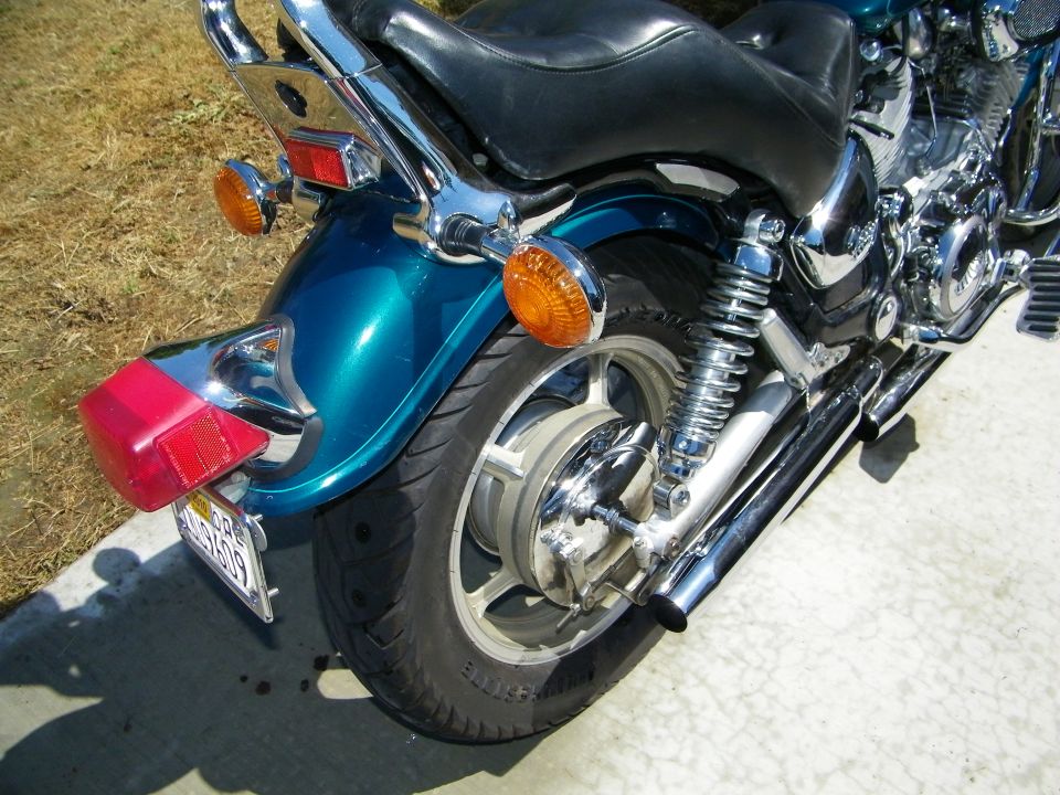 Teal motorcycle rear fender, wheel, and exhaust. 1992 Yamaha Virago