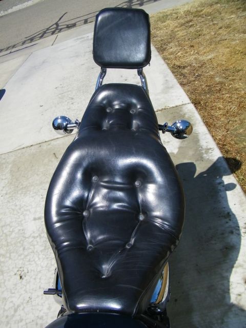 1992 Yamaha Virago - A close-up view of a motorcycle's black leather seat and backrest, with chrome accents visible.