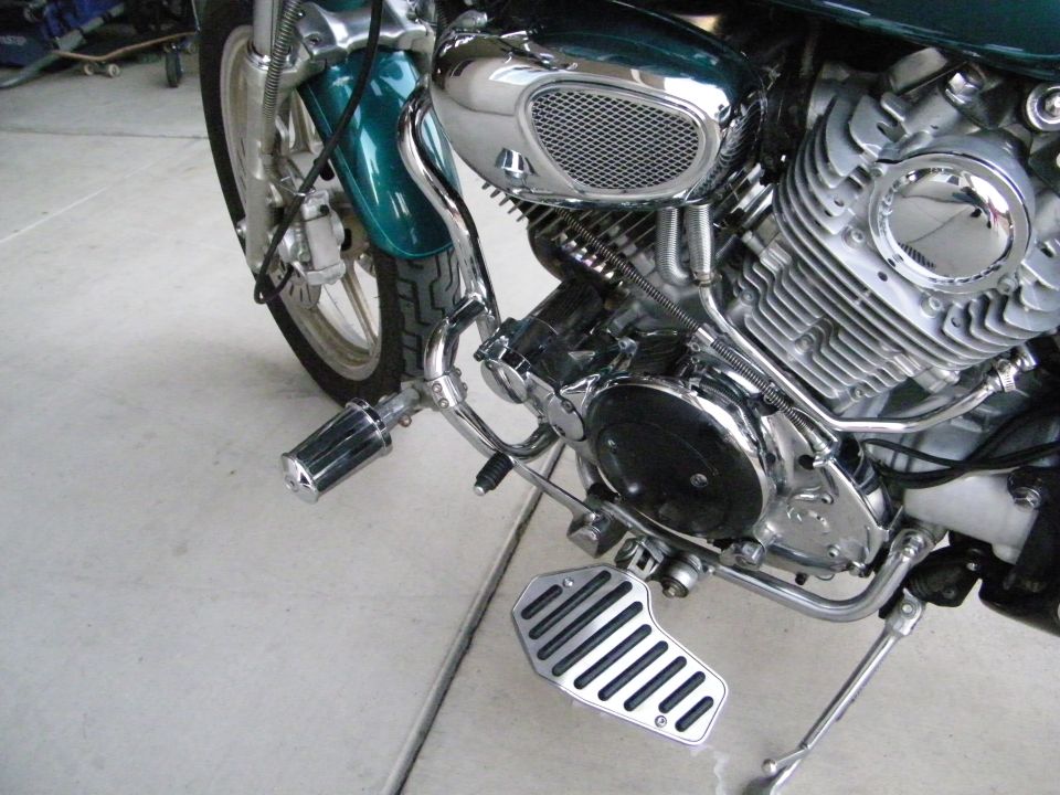 Green motorcycle engine and front wheel with chrome accents