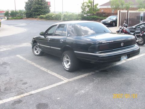1993 Mercury Grand Marquis - This 1993 Mercury Grand Marquis features a raised suspension and aftermarket wheels, giving it a unique stance.