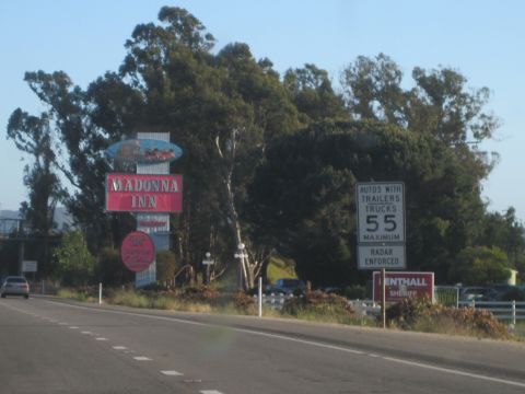 1989 Toyota Pickup/SR5 - A roadside scene the iconic Madonna Inn sign and a speed limit sign indicating 55 MPH maximum, radar enforced.