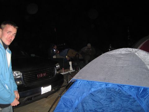 1989 Toyota Pickup/SR5 - A group of people are camping at night next to a GMC Sierra pickup truck.