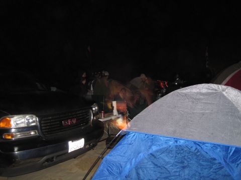 1989 Toyota Pickup/SR5 - A black GMC Sierra pickup truck is parked at a campsite at night.