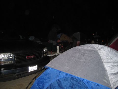1989 Toyota Pickup/SR5 - A GMC truck is parked at a campsite with tents set up around it.
